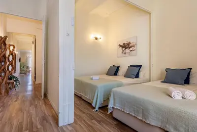 a room with two beds and a hallway at Aragó Suites in Barcelona