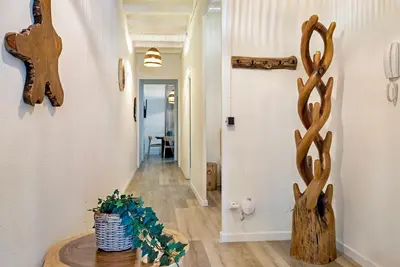 a hallway with antlers on the wall and a table at Aragó Suites in Barcelona