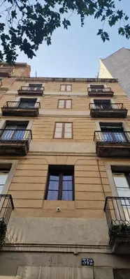 a tall building with windows and balconies on it at Aragó Suites in Barcelona