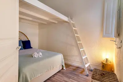 a bedroom with a bunk bed with a ladder at Aragó Suites in Barcelona