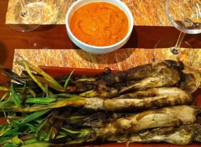 a plate of food with vegetables and a bowl of soup at Casita rural con piscina in La Torre de Claramunt