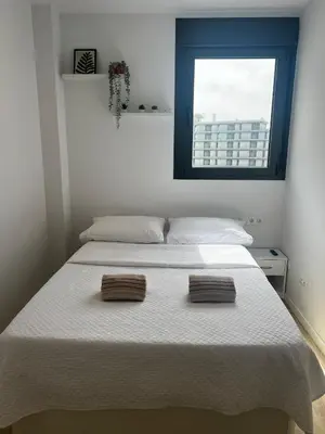 a bedroom with a bed with two towels on it at Confortable habitación doble - 2 in Sant Adria de Besos