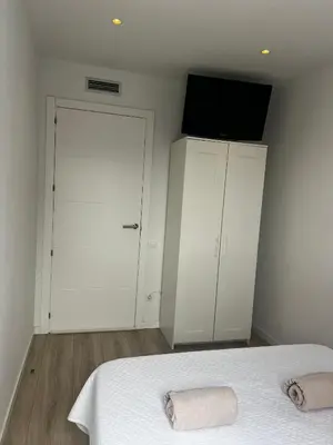a bedroom with a bed with a television and a closet at Confortable habitación doble - 2 in Sant Adria de Besos