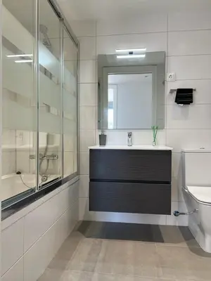 a bathroom with a sink and a toilet and a mirror at Confortable habitación doble - 2 in Sant Adria de Besos
