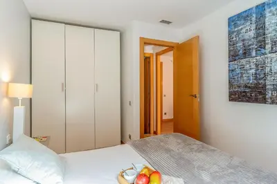 a bedroom with a bed with a bowl of fruit on it at 1520 - AB Eixample Sicília Apartment in Barcelona