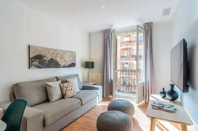 a living room with a couch and a tv at 1520 - AB Eixample Sicília Apartment in Barcelona