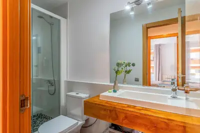 a bathroom with a sink and a toilet and a mirror at 1520 - AB Eixample Sicília Apartment in Barcelona