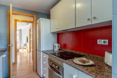 a kitchen with red walls and a counter top at 1520 - AB Eixample Sicília Apartment in Barcelona