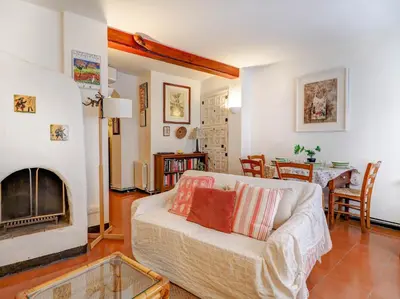 a living room with a couch and a fireplace at Red Velvet Apartment by Hello Homes Sitges in Sitges