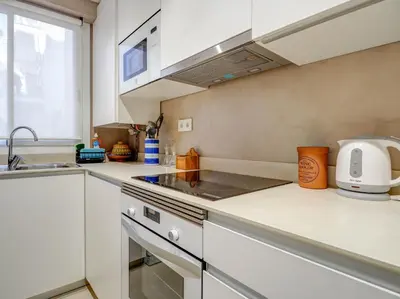 a kitchen with a sink and a stove top oven at Red Velvet Apartment by Hello Homes Sitges in Sitges