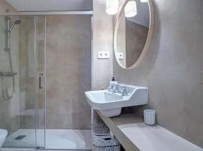 a bathroom with a sink and a shower and a mirror at Red Velvet Apartment by Hello Homes Sitges in Sitges