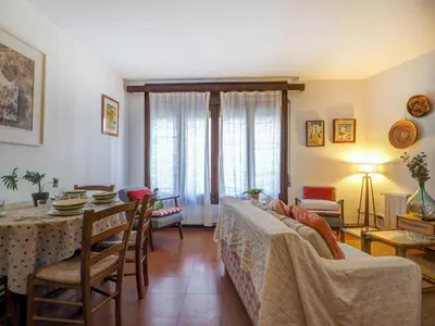 a living room with a table and a dining room at Red Velvet Apartment by Hello Homes Sitges in Sitges