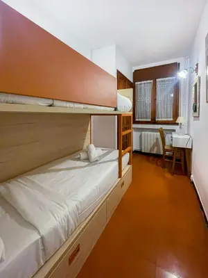 a bedroom with two bunk beds and a desk at Red Velvet Apartment by Hello Homes Sitges in Sitges