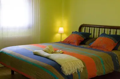 a bedroom with a bed with a book on it at Ca l'Helena in Castellet