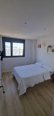 a bedroom with a white bed with two towels on it at Confortable habitación doble - 1 in Sant Adria de Besos