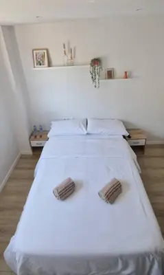 a bedroom with a white bed with two towels on it at Confortable habitación doble - 1 in Sant Adria de Besos