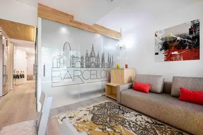 two beds with orange pillows in a room at II-II Hub Luxury New Apartments in Barcelona
