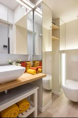 a stainless steel refrigerator in a kitchen with white cabinets at II-II Hub Luxury New Apartments in Barcelona