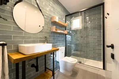 a bathroom with a sink and a toilet and a mirror at Bebarceloner Poble Nou Apartments - 1 bedroom in Barcelona