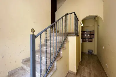 a staircase with a blue rail in a building at Bebarceloner Poble Nou Apartments - 1 bedroom in Barcelona