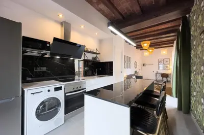 a kitchen with a washer and dryer at Bebarceloner Poble Nou Apartments - 1 bedroom in Barcelona