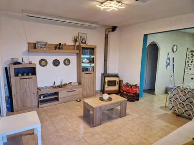 a living room with a table and a stove at Le Petit Paradis Olivella in Olivella