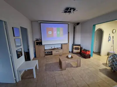a living room with a large flat screen tv at Le Petit Paradis Olivella in Olivella