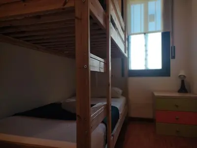 a bedroom with two bunk beds and a window at Ap4Us B1 - Apartment for us - Sightseeing & Beach near to Barcelona in Badalona