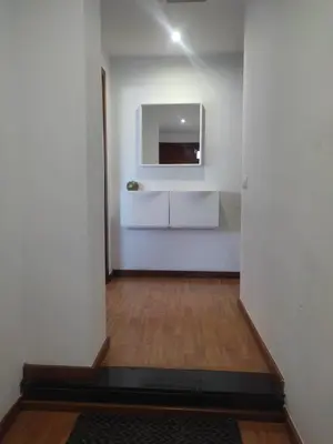 a room with a white wall with a tv on it at Ap4Us B1 - Apartment for us - Sightseeing & Beach near to Barcelona in Badalona