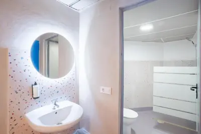 a bathroom with a sink and a mirror at Malacuna Barcelona in Barcelona