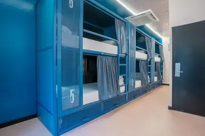 an empty room with blue bunk beds at Malacuna Barcelona in Barcelona