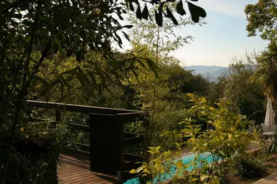 a plunge pool in a garden with mountains in the background at Casa Magnolia in Dosríus