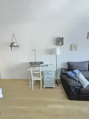 a living room with a desk and a couch at Beach Apartment Barca 6 in Sant Adria de Besos