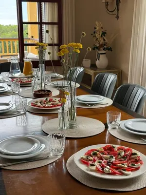 a table with plates of food on top of it at Villa Golf Sitges in Vilanova i la Geltrú