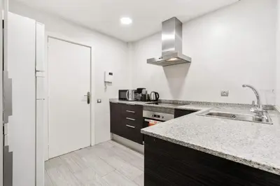 a kitchen with a sink and a counter top at Sunny Terrace Retreat AC 3BR2BA in Barcelona