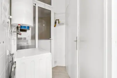 a white bathroom with a sink and a shower at Sunny Terrace Retreat AC 3BR2BA in Barcelona