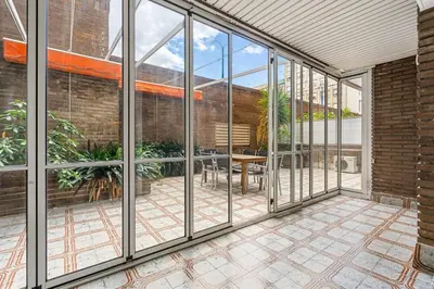 an internal view of a conservatory with windows and a patio at Sunny Terrace Retreat AC 3BR2BA in Barcelona