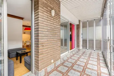 a brick wall in a living room with a couch at Sunny Terrace Retreat AC 3BR2BA in Barcelona