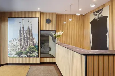 a lobby with a bar with a picture of a building at Hotel Cortes Rambla in Barcelona