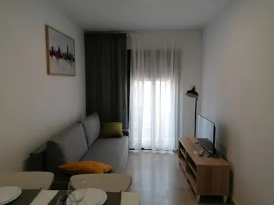 a living room with a couch and a tv at Piso pl 2B, 20min Plaza Cataluña in Sant Adria de Besos