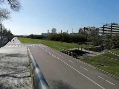 an empty road next to a park with buildings at Piso pl 2B, 20min Plaza Cataluña in Sant Adria de Besos