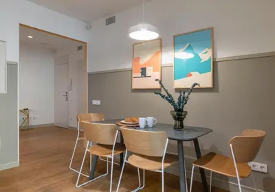 a dining room with a table and chairs at Aspasios City Oasis Apartments in Barcelona