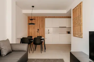 a living room and kitchen with a table and chairs at Europa Apartments in Hospitalet de Llobregat