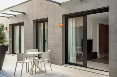 a room with a table and chairs in a building at Europa Apartments in Hospitalet de Llobregat
