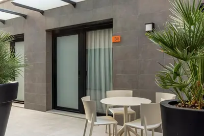 a room with a table and chairs and plants at Europa Apartments in Hospitalet de Llobregat