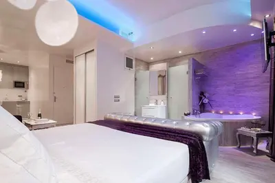 a bedroom with a large bed and a sink at Romantic Barcelona Apartment in Barcelona