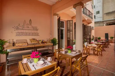 a patio with tables and chairs in a restaurant at Antonios Hostal in Sitges