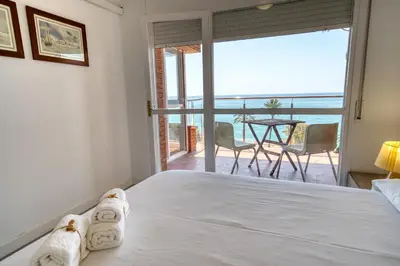 a bedroom with a bed and a view of the ocean at HomeHolidaysRentals Aquilone - Costa Barcelona in Pineda de Mar