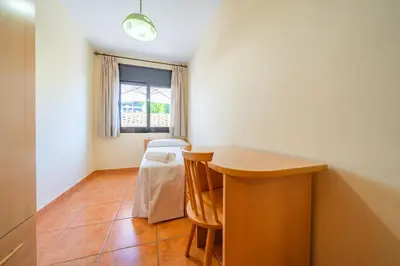 a room with a table and two chairs and a window at HomeHolidaysRentals Fortuny - Costa Barcelona in Pineda de Mar
