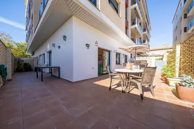 an outdoor patio with a table and chairs at HomeHolidaysRentals Fortuny - Costa Barcelona in Pineda de Mar
